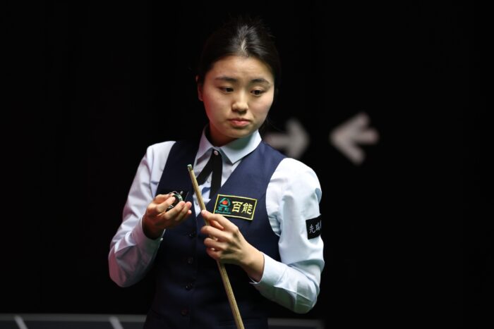 Bai Yulu, a young chinese player, at the table, chalking her cue